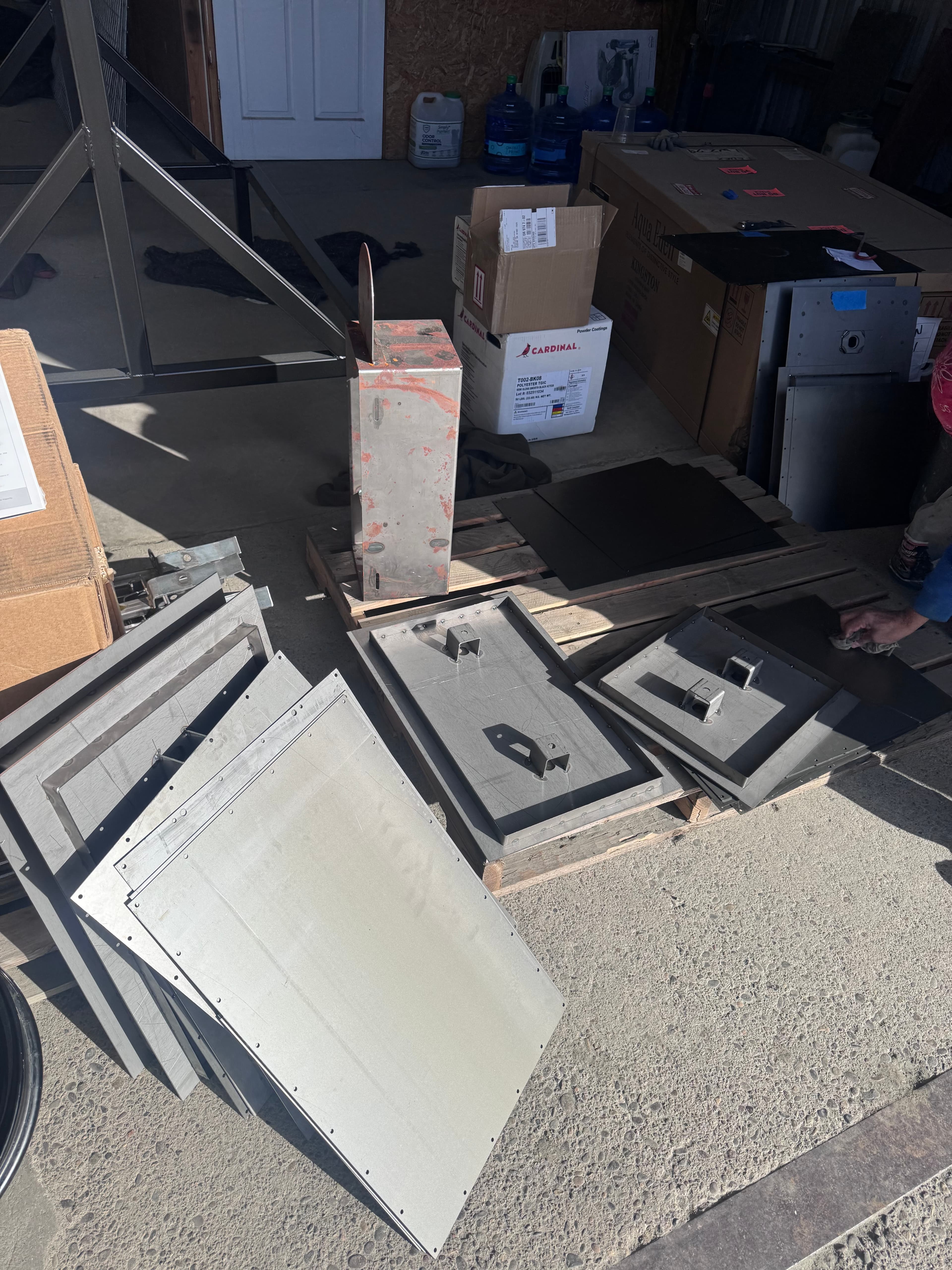 Steel panels and components staged for SquareVac assembly