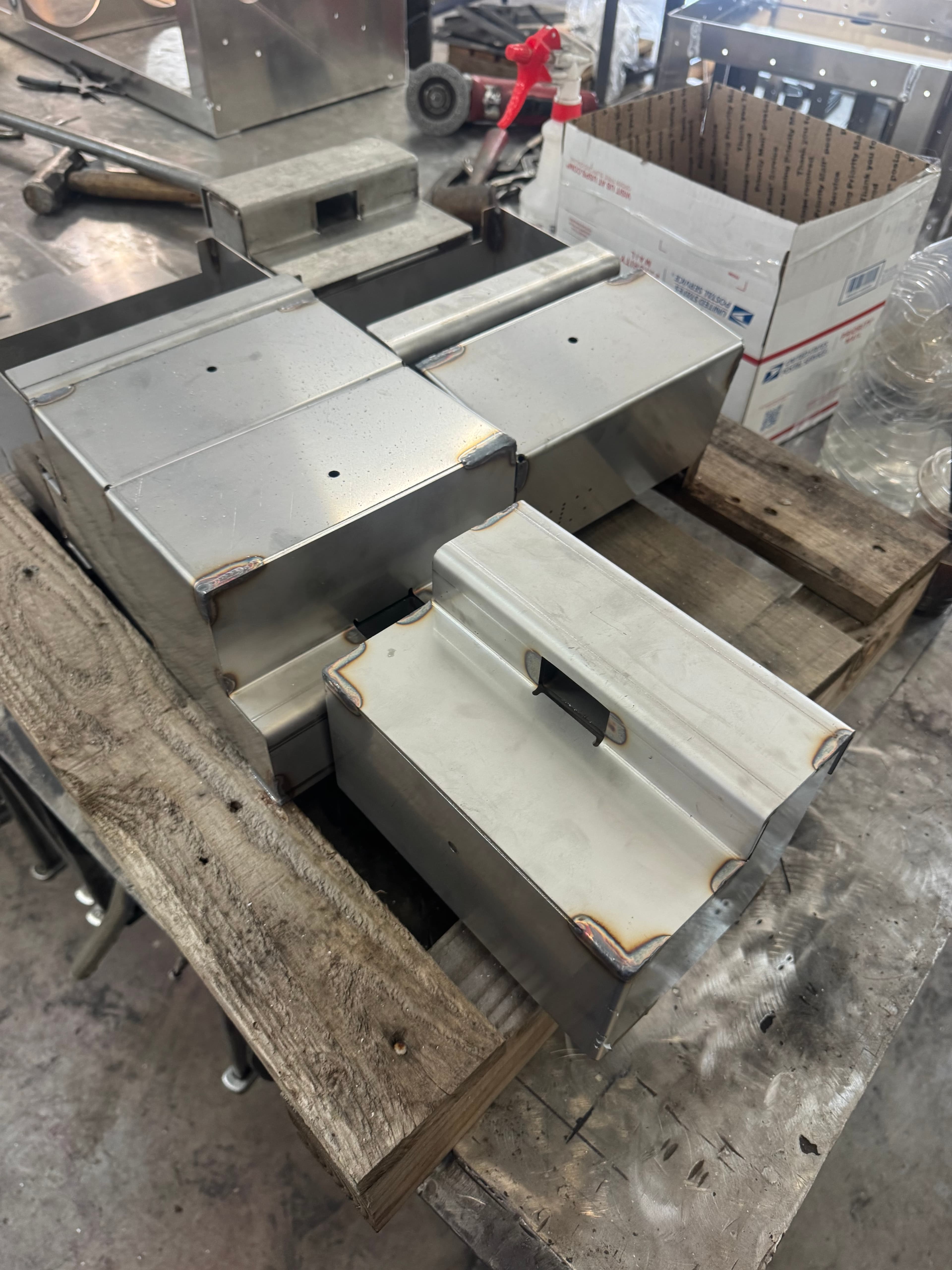 Completed stainless steel SquareVac canisters on workbench